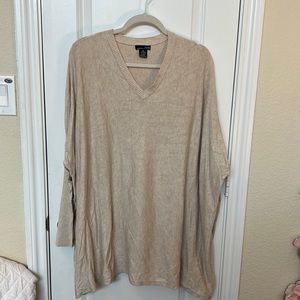 Oversized, lightweight sweater. Gold snap detail on ribbed, fitted sleeves.